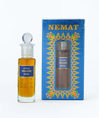 Attar Shaahi Oud perfume oil bottle with decorative blue box, niche fragrance product