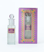 Sandalwood attar perfume in clear glass bottle with decorative purple box, labeled 726.