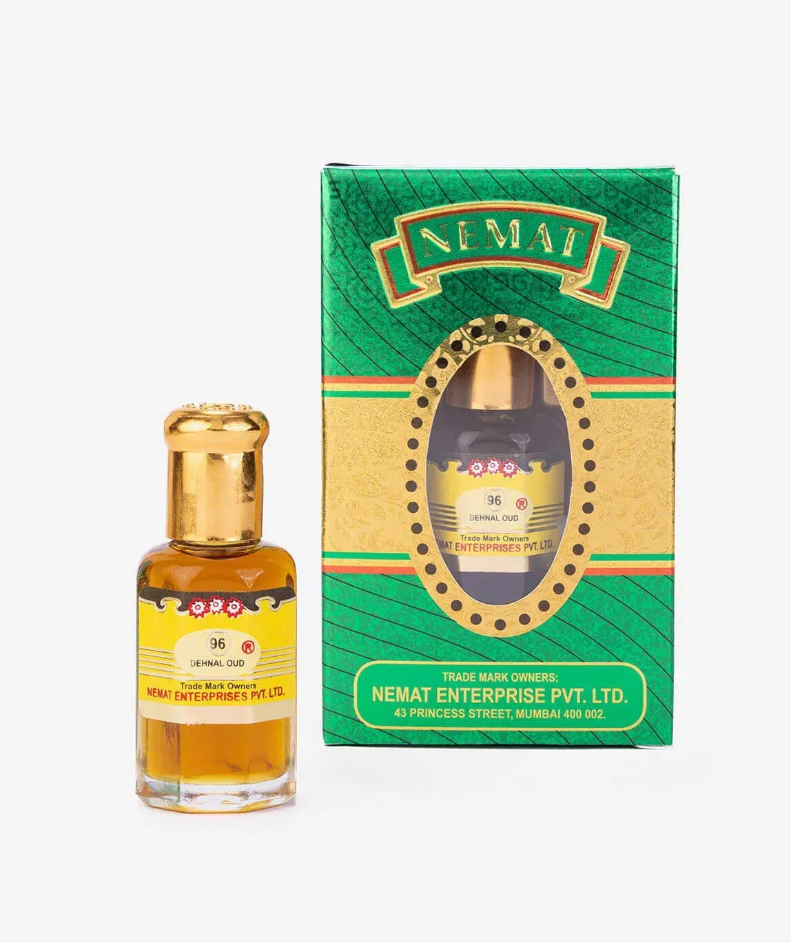 Dehnal Oud perfume oil bottle with gold cap next to green and gold packaging
