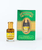 Black Oud perfume oil bottle with gold cap and matching green and gold retail box