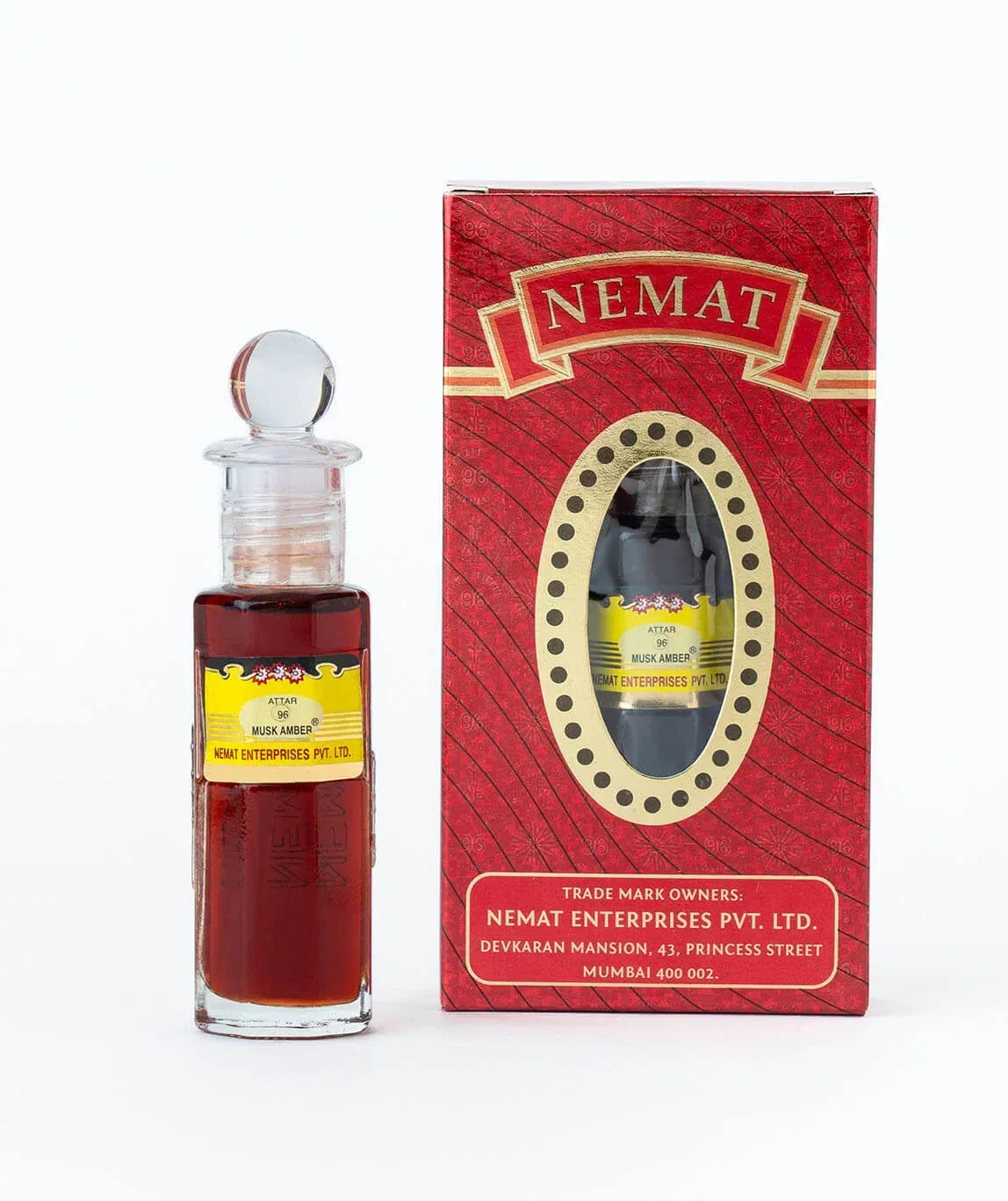 Glass bottle of Musk Amber attar with red and gold packaging, Nemat Enterprises visible