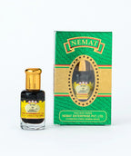 Attar perfume oil bottle with gold cap next to green and gold Nemat box, labeled Fancy Bouquet.