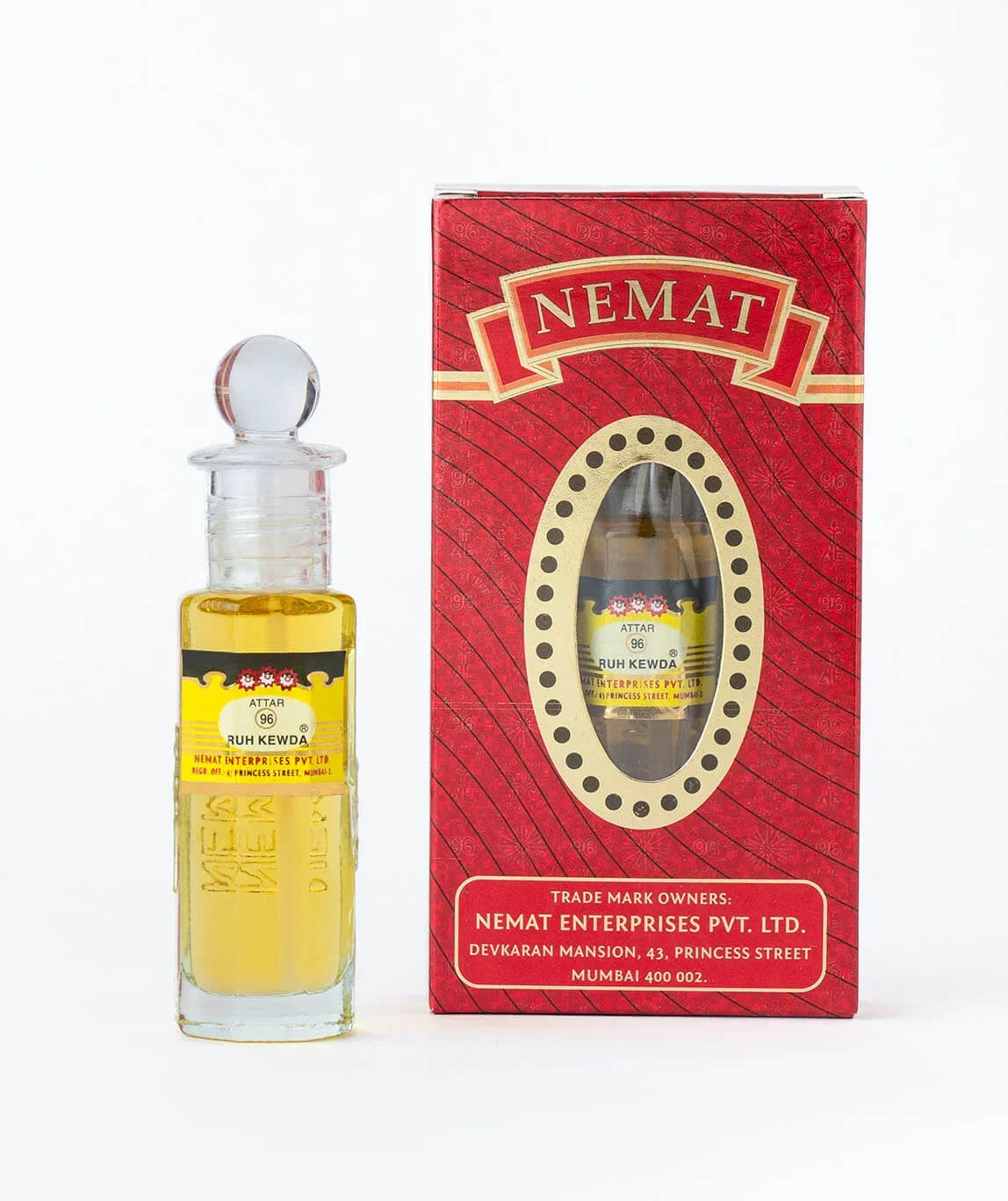 Ruh Kewda attar perfume oil bottle with ornate glass stopper beside red decorative box